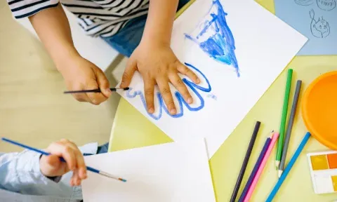 A child focused on a hands-on craft activity